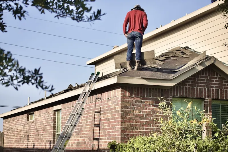 Professional roofer working on a residential roof in Prairie Grove